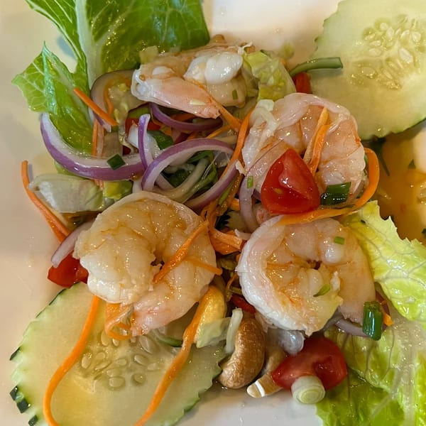 Pattaya Thai's spicy shrimp salad with lettuce, red onions, carrots, tomatoes, and cucumbers.