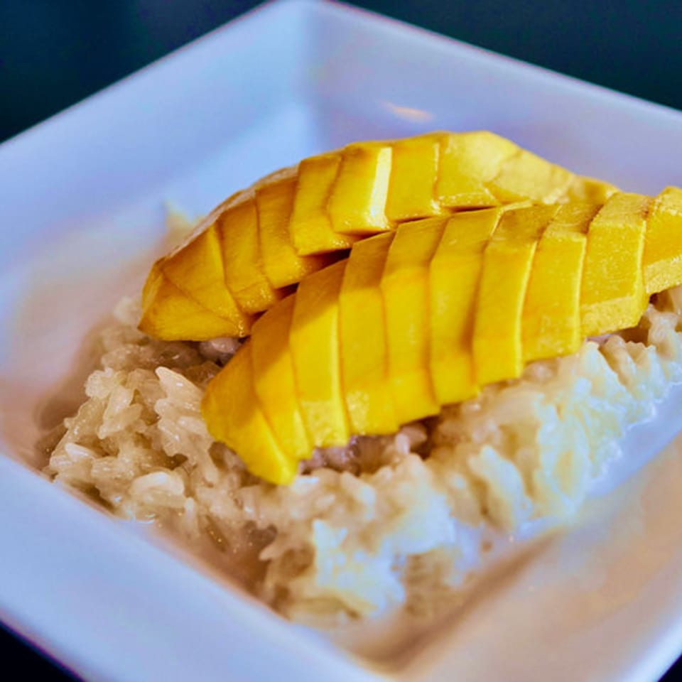 Pattaya Thai's mango sticky rice dessert, with sliced mango over white sticky rice and coconut milk.