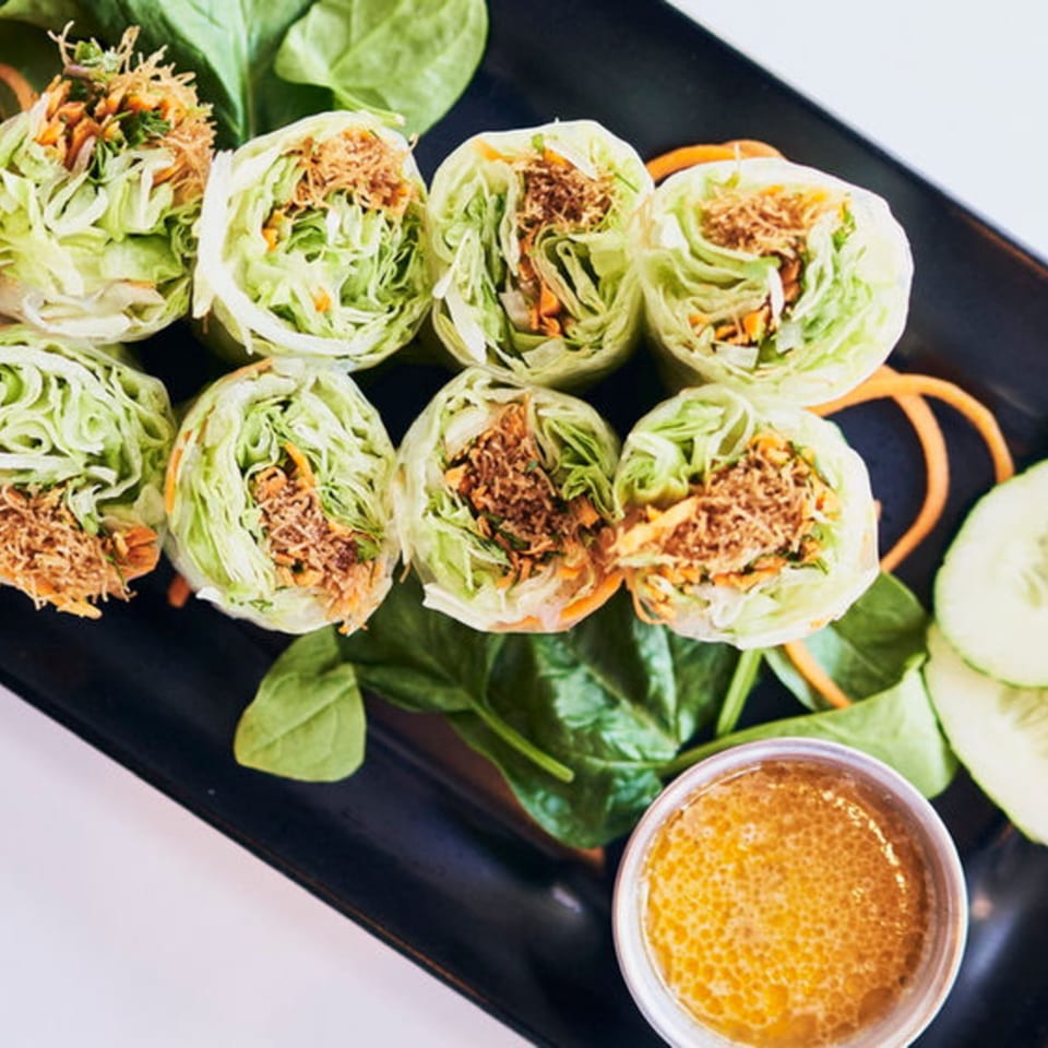 Pattaya Thai fresh spring rolls with shredded vegetables and meat, served with dipping sauce.